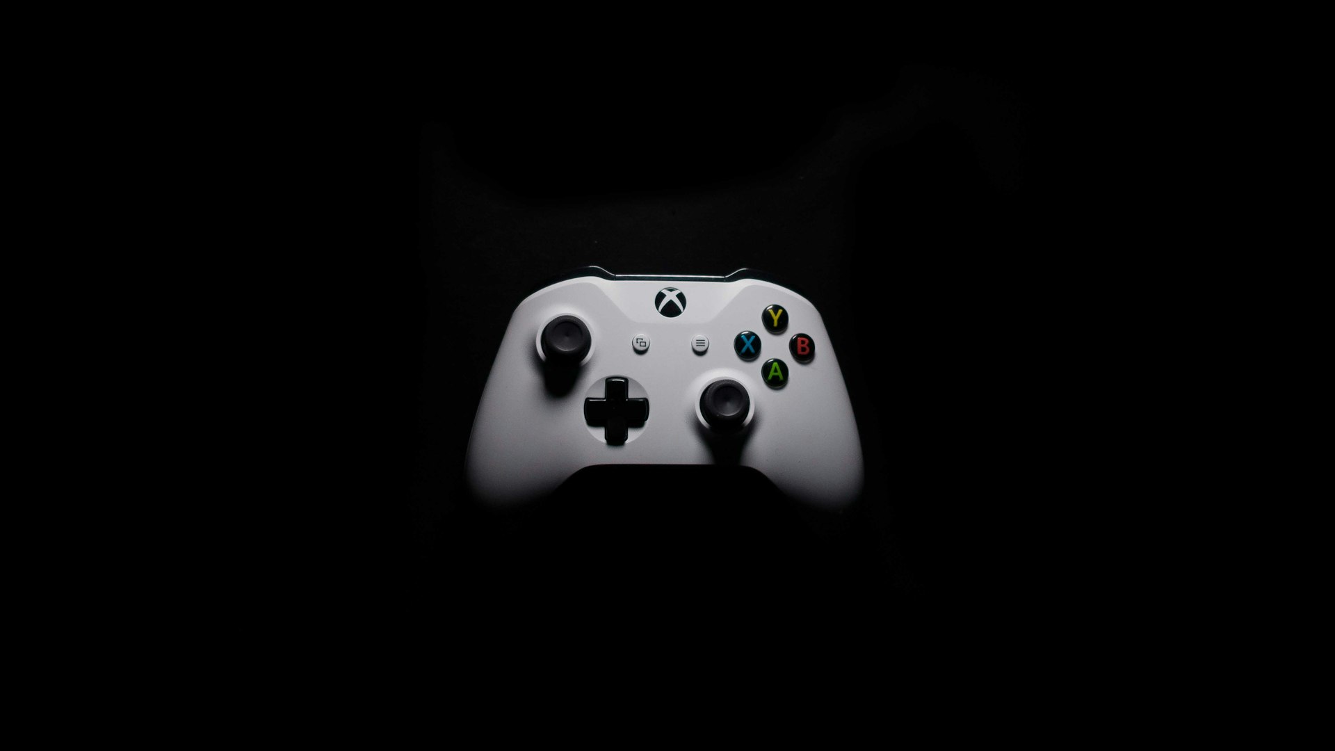 A dimly lit gaming setup glowing against a dark room